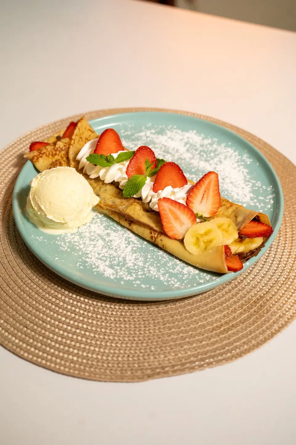 Crepe with strawberries and ice cream