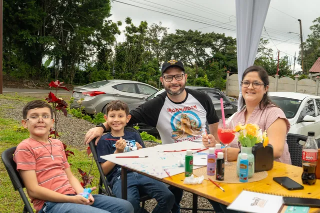 Family sharing drinks and food on the Garabatos Naranjo patio