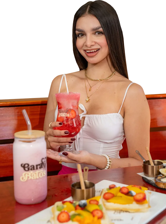 Smiling guest holding a strawberry Soda Garabatos